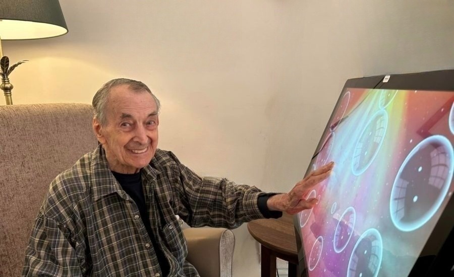 Care home resident using a sensory app on the Happi Table