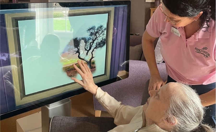 Care home resident emjoying a dementia colouring app on the Happi Table